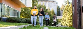 Four students walking outside of Allard Hall